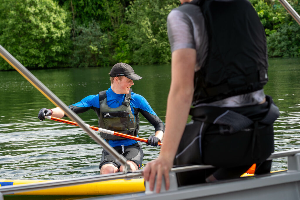 boy paddling in reservoir